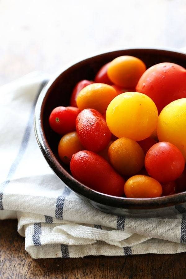 Tomatoes in a black bowl.