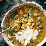 Detox Crockpot Lentil Soup in bowl with a spoon.