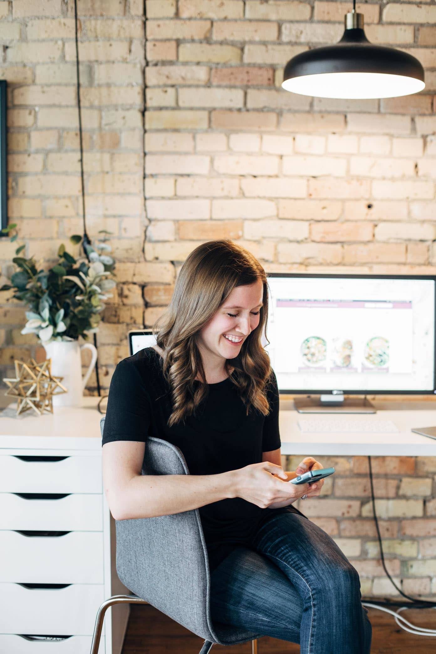 Woman sitting in a chair in an office.
