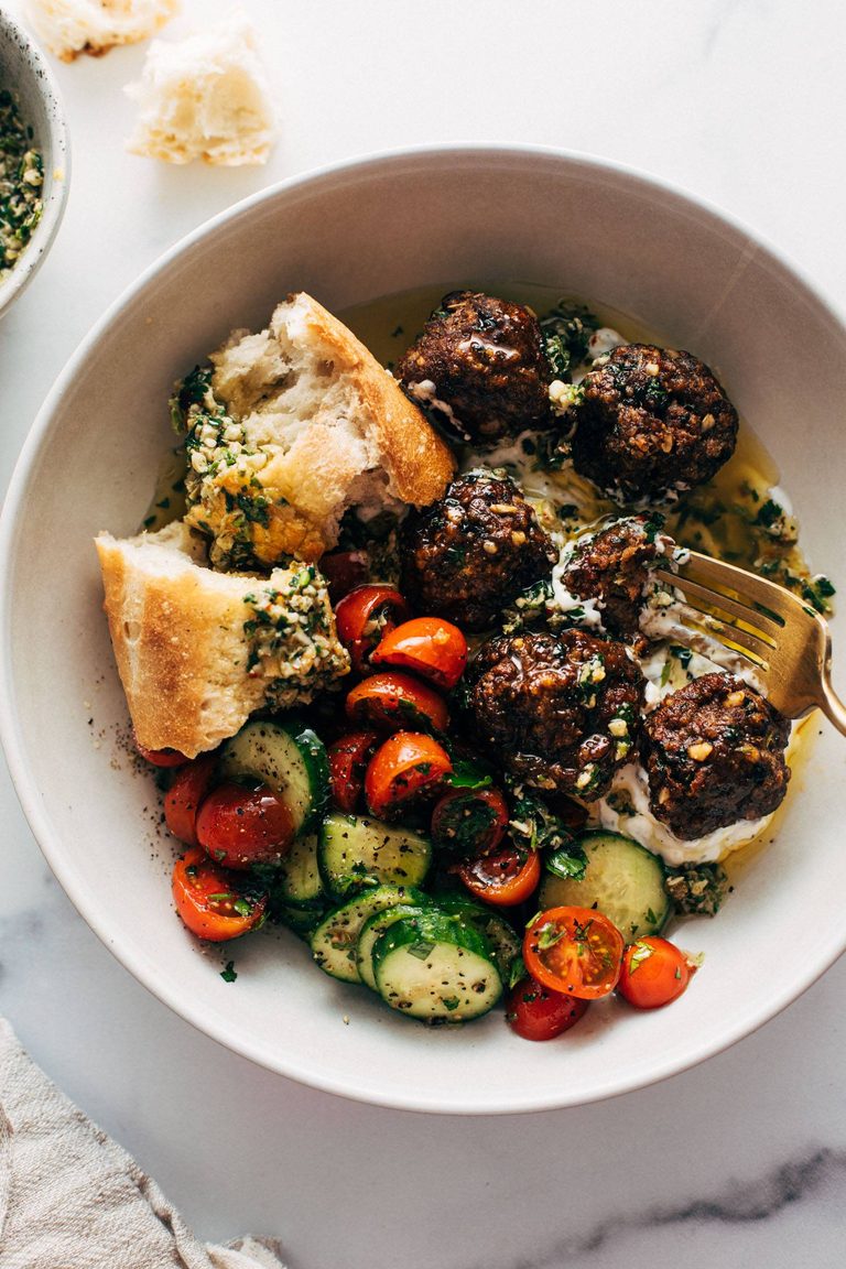 Sheet pan meatballs with tomato salad and bread.