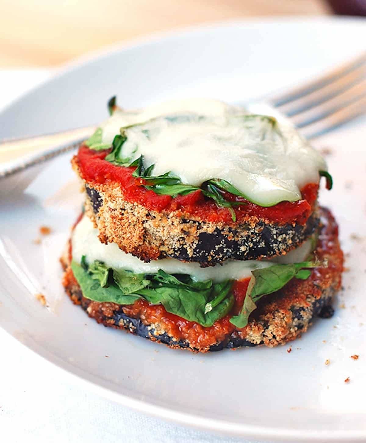 Eggplant pizza on a plate with a fork.